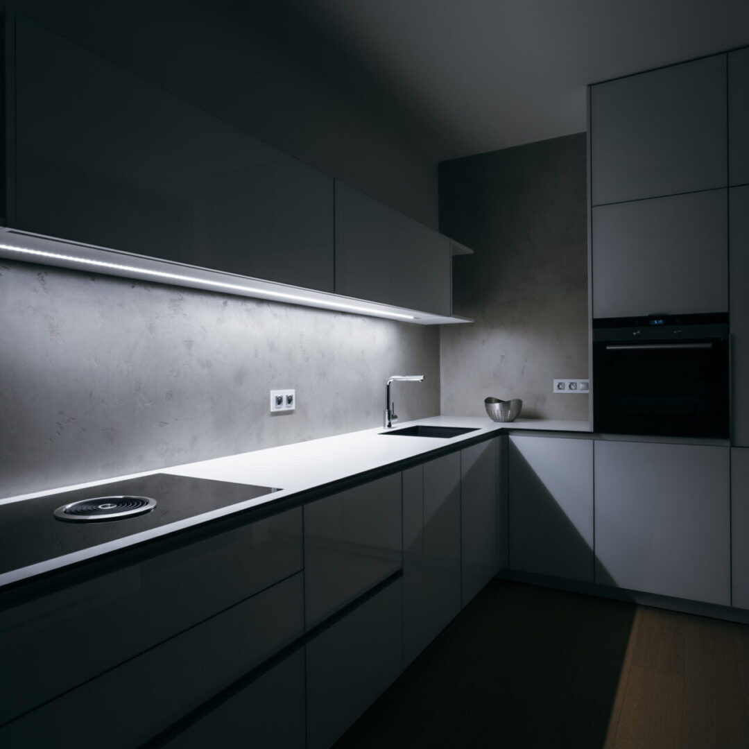 Modern white kitchen in minimalist design, in night, with light